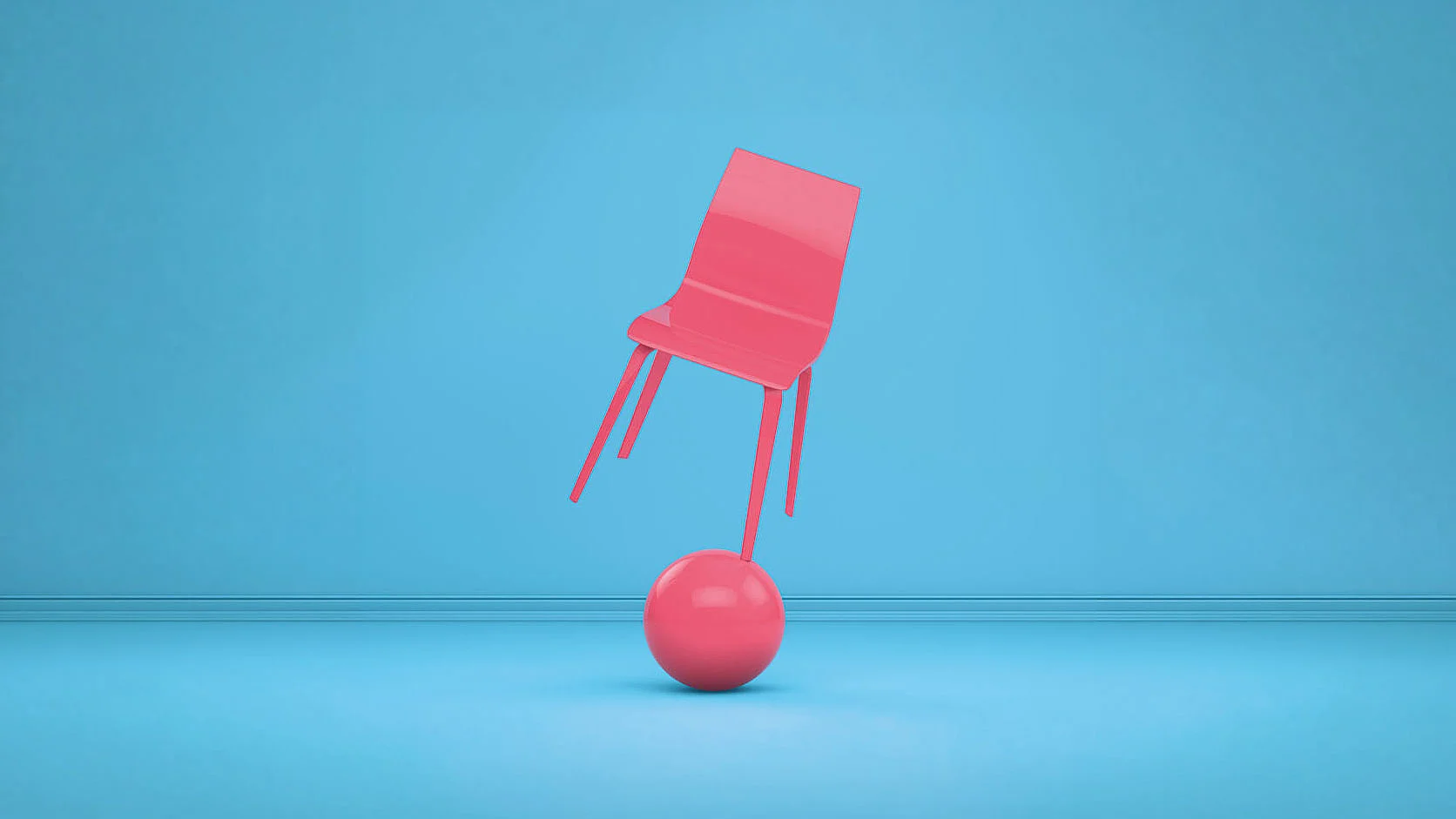 Roter Stuhl balanciert auf einer roten Kugel vor blauem Hintergrund.